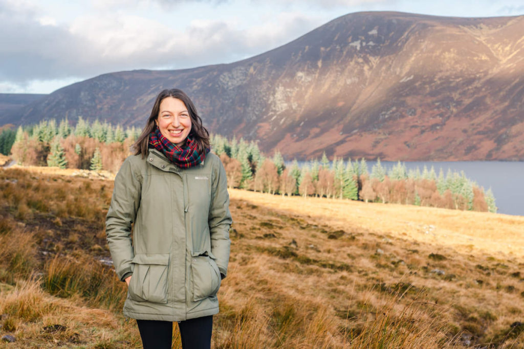 Karen Thorburn, photographer, standing outdoors in a green jacket in the Scottish countryside